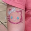 glitter kitty tattoo on arm